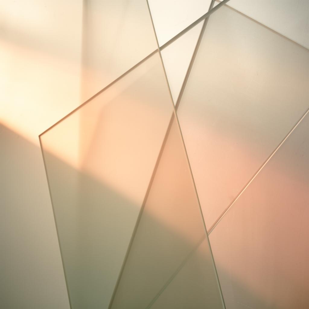 Layered translucent glass panels catching warm morning light